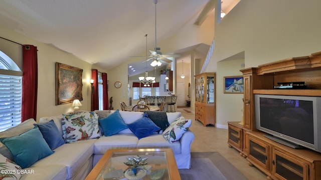 tiled living room featuring high vaulted ceiling and ceiling fan with notable chandelier