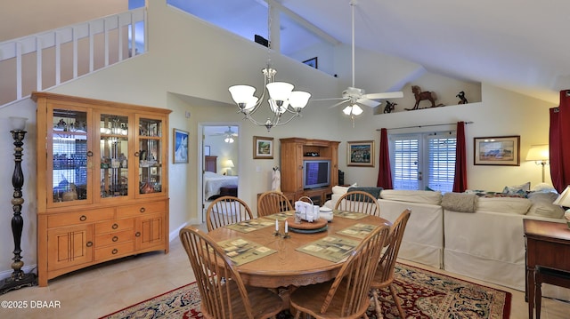 dining room featuring light tile patterned floors, ceiling fan with notable chandelier, and high vaulted ceiling