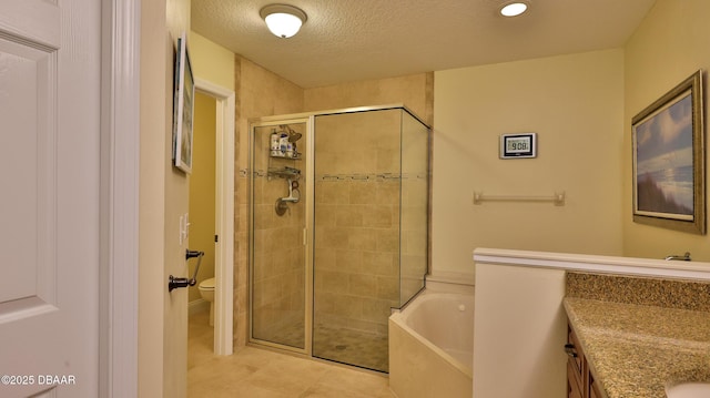 full bathroom with a textured ceiling, tile patterned flooring, vanity, toilet, and separate shower and tub