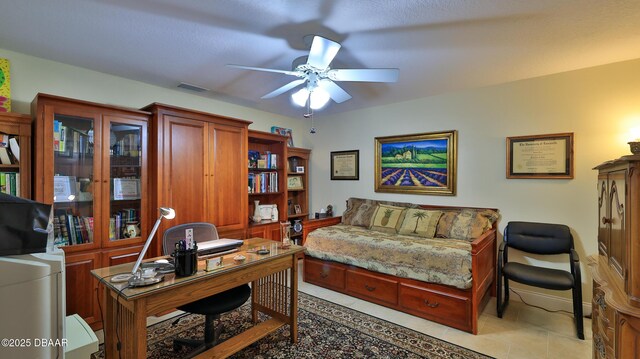 home office with ceiling fan and light tile patterned floors