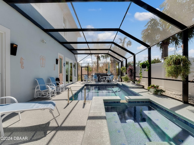 view of swimming pool with a lanai, a patio, and an in ground hot tub