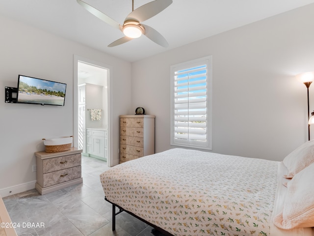 tiled bedroom with ensuite bath and ceiling fan