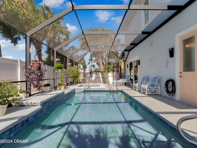 view of pool featuring an in ground hot tub, a patio, and a lanai