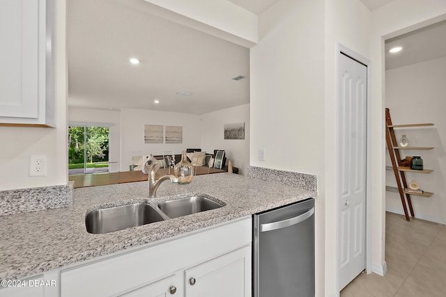 kitchen featuring white cabinetry, sink, light stone counters, and dishwasher