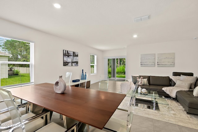 dining space featuring light tile patterned flooring