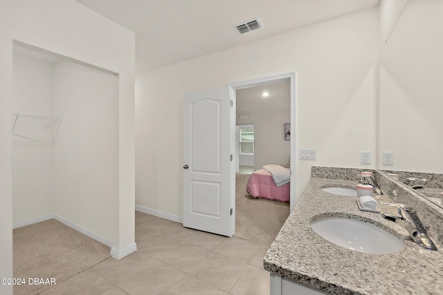 bathroom with vanity and tile patterned flooring