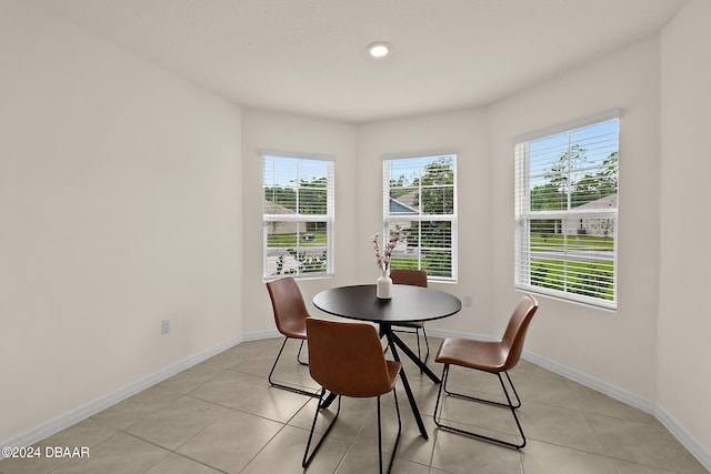 dining area featuring light tile patterned flooring and a healthy amount of sunlight