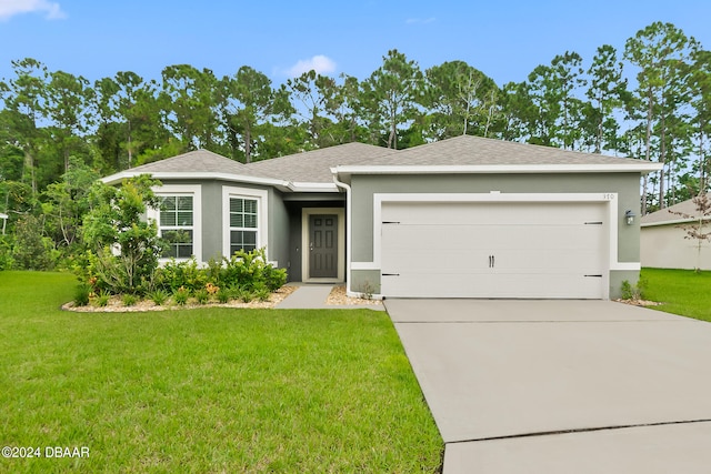 view of front of property with a garage and a front yard