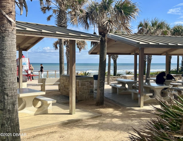 view of patio with a water view and a gazebo