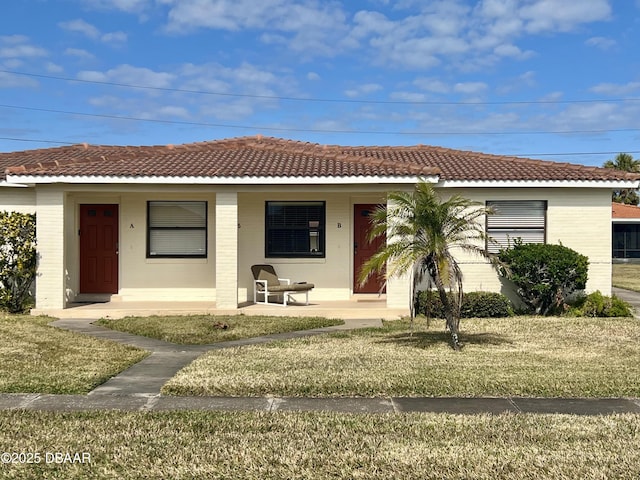 view of front of house with a front yard and covered porch