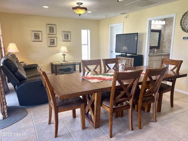 tiled dining area featuring sink