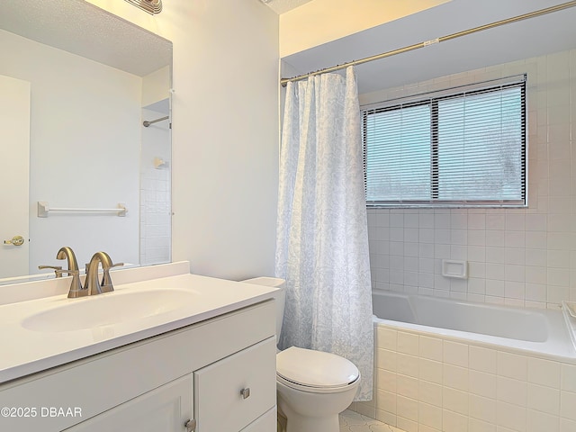 bathroom featuring toilet, tiled shower / bath combo, and vanity