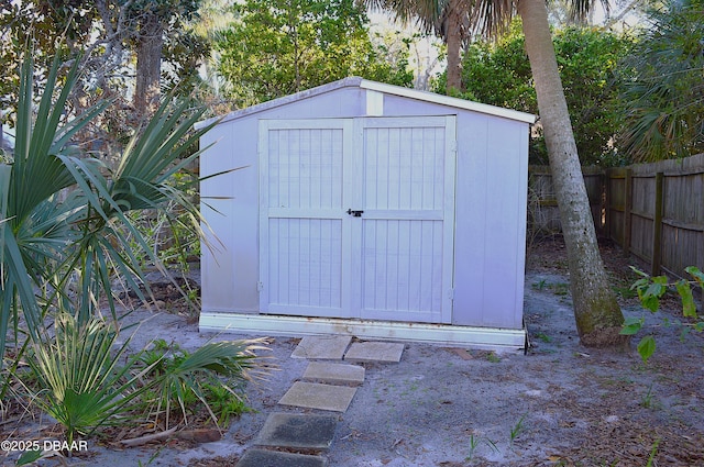 view of shed with fence