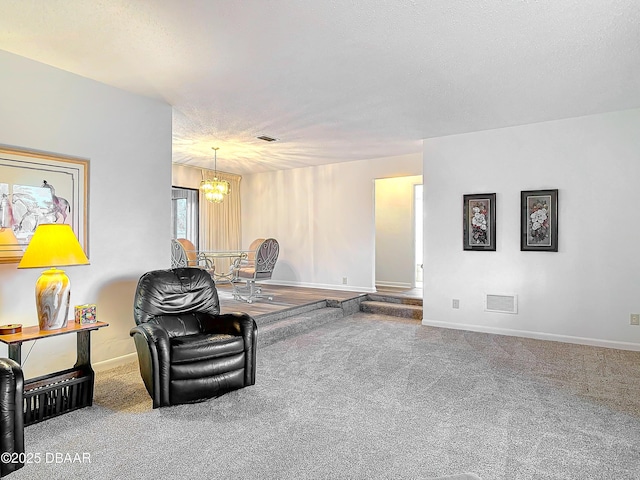 sitting room with visible vents, carpet flooring, a textured ceiling, a chandelier, and baseboards