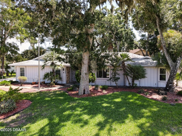 view of front facade featuring board and batten siding and a front yard