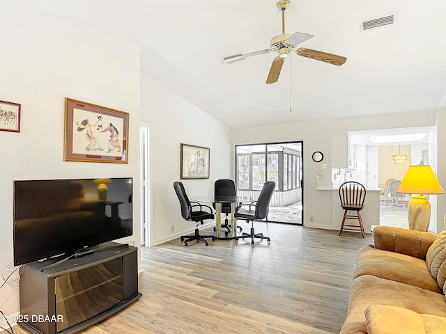 interior space with visible vents, baseboards, light wood-style flooring, ceiling fan, and high vaulted ceiling