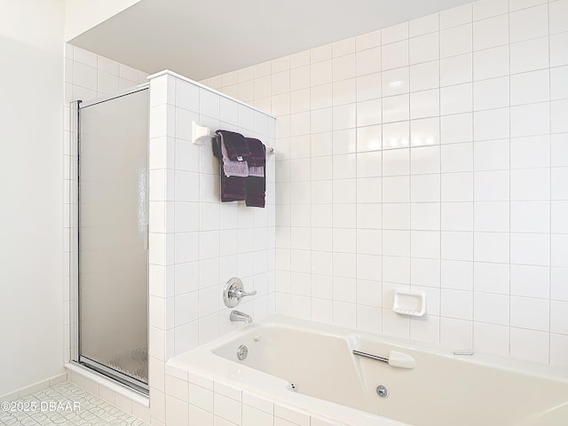 full bathroom with a stall shower, a jetted tub, and tile patterned floors