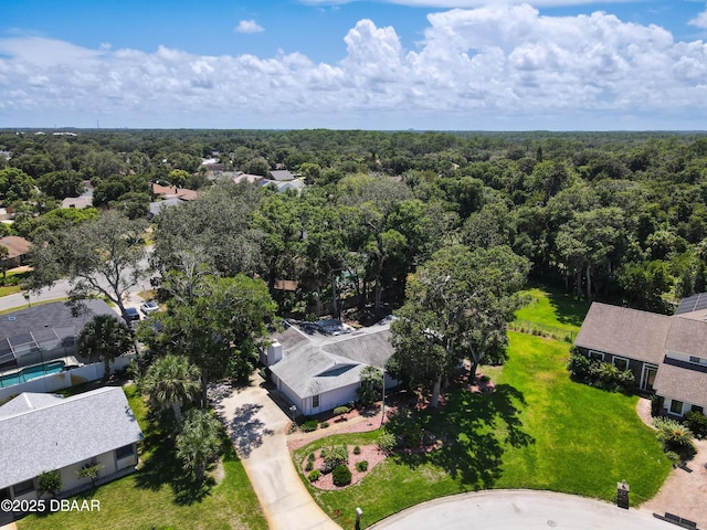 drone / aerial view featuring a forest view and a residential view