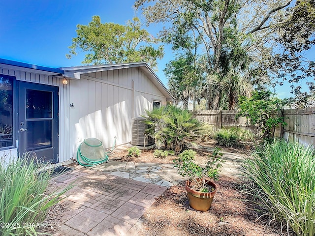 view of patio featuring central AC unit and fence