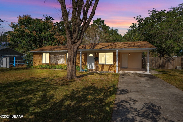 single story home featuring a yard and a carport