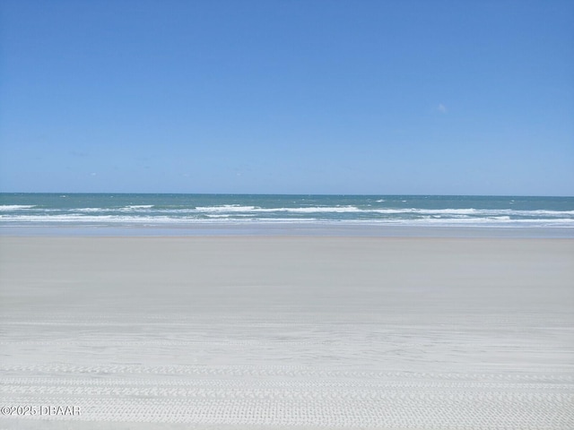 view of water feature with a beach view