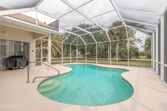 view of pool with a patio area, area for grilling, and glass enclosure