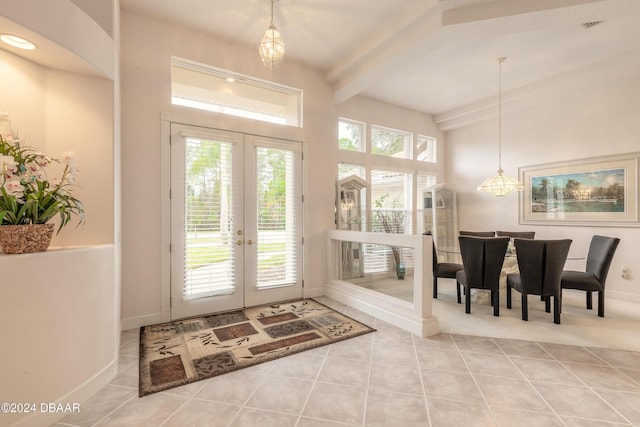 doorway with beam ceiling, french doors, light tile patterned flooring, and a notable chandelier