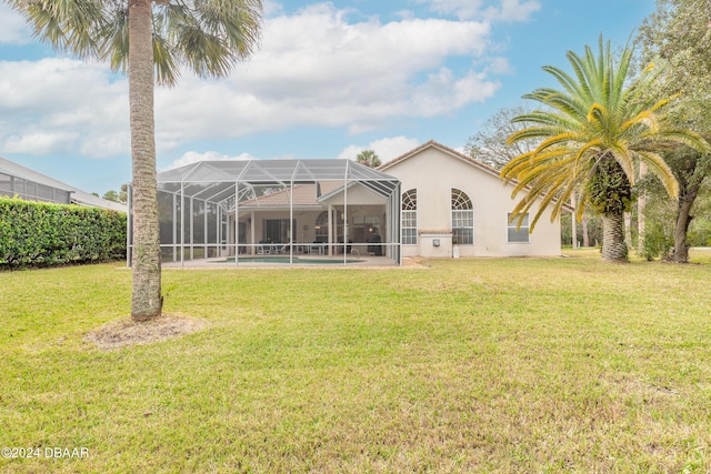 rear view of property featuring a yard and a lanai