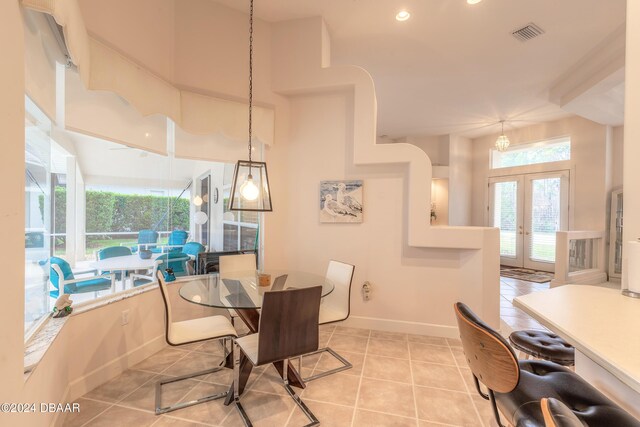 dining room with french doors and light tile patterned floors