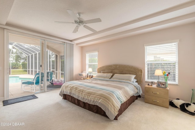 carpeted bedroom with access to outside, ceiling fan, and a textured ceiling