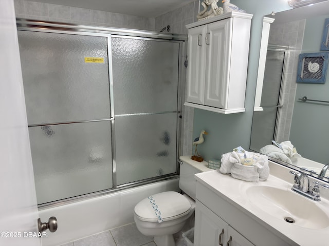 2615 S Atlantic Ave Unit 1D, Daytona Beach, FL 32118 - bathroom with vanity, combined bath / shower with glass door, toilet, and tile patterned flooring