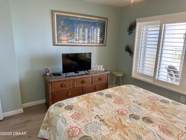 2615 S Atlantic Ave Unit 1D, Daytona Beach, FL 32118 - bedroom featuring wood finished floors, multiple windows, and baseboards
