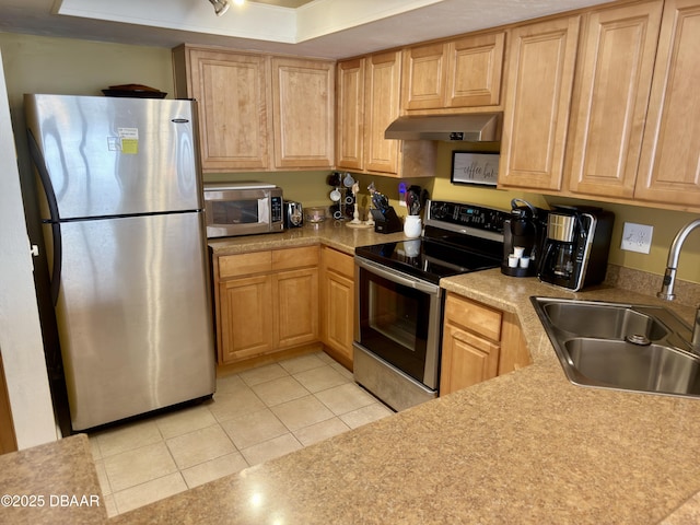 2615 S Atlantic Ave Unit 1D, Daytona Beach, FL 32118 - kitchen featuring appliances with stainless steel finishes, a sink, under cabinet range hood, light tile patterned floors, and light countertops