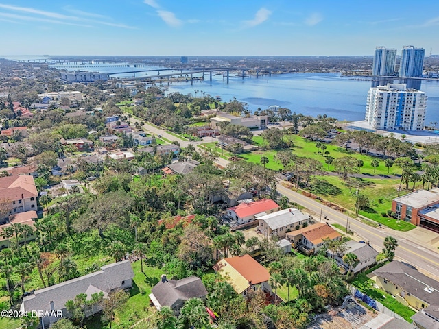 drone / aerial view featuring a city view and a water view