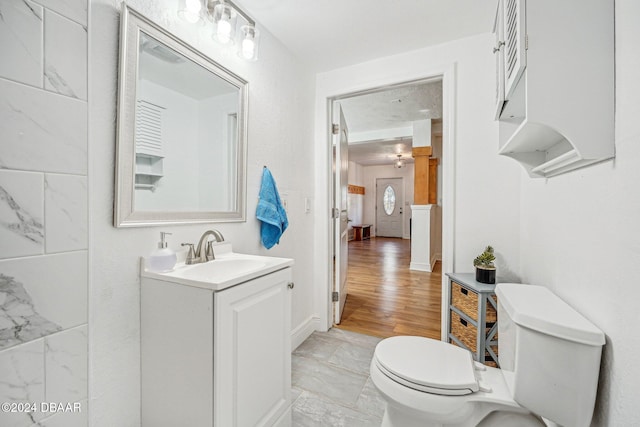 bathroom with vanity, hardwood / wood-style flooring, and toilet