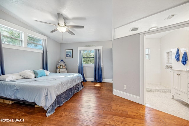 bedroom with visible vents, hardwood / wood-style floors, baseboards, lofted ceiling, and ceiling fan