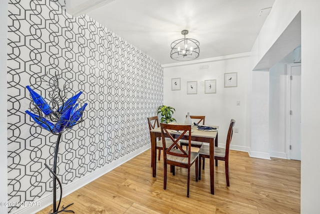 dining room with light wood-type flooring and a chandelier