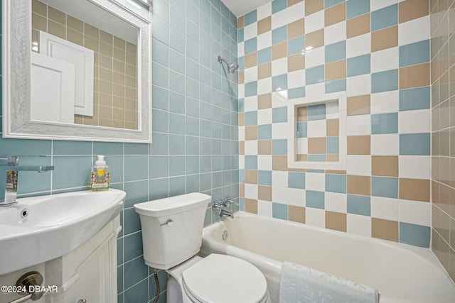 full bathroom with tile walls, toilet, vanity, and bathtub / shower combination