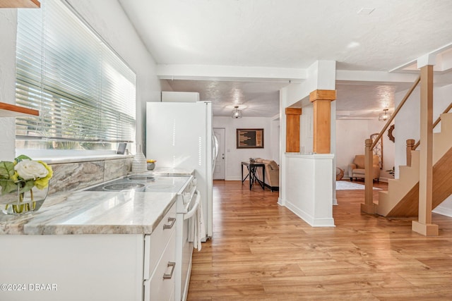 kitchen with light hardwood / wood-style floors, light stone countertops, a textured ceiling, white range oven, and white cabinets