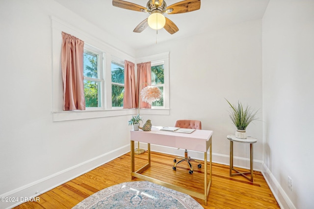 office with hardwood / wood-style flooring and ceiling fan