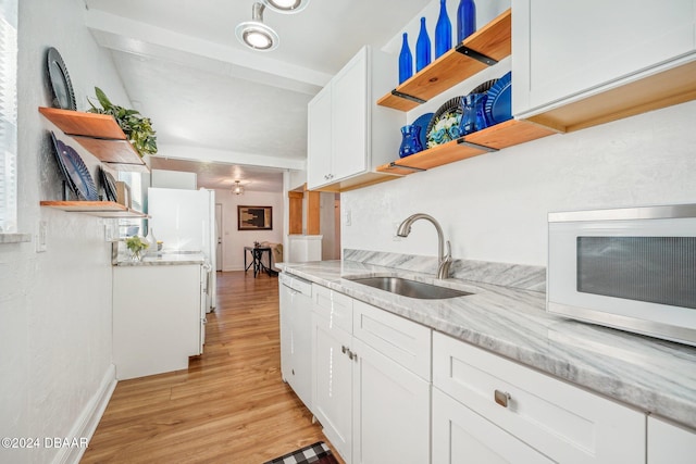 kitchen featuring white appliances, open shelves, light wood-style flooring, a sink, and white cabinetry