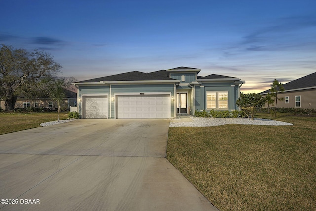 view of front of house with a garage and a lawn