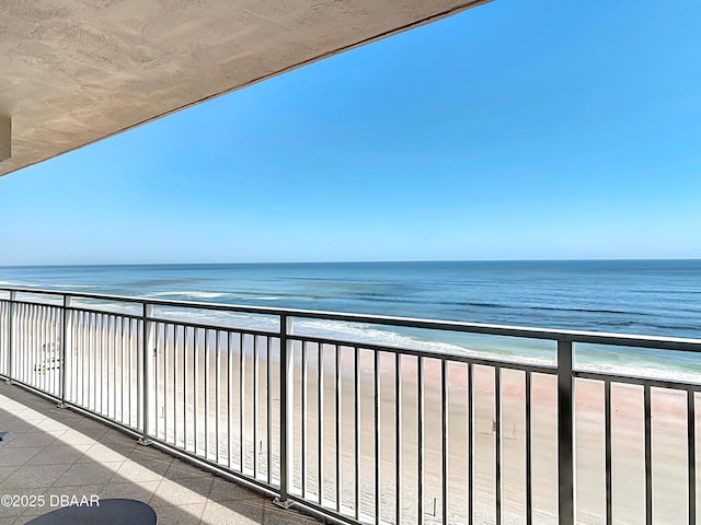 balcony with a view of the beach and a water view