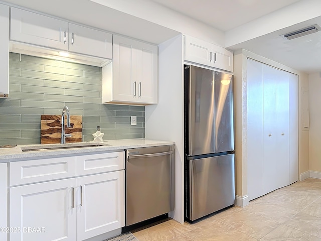 3333 S Atlantic Ave Unit 505, Daytona Beach, FL 32118 - kitchen featuring stainless steel appliances, a sink, white cabinetry, and light countertops