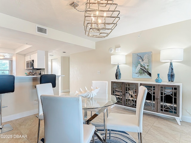 3333 S Atlantic Ave Unit 505, Daytona Beach, FL 32118 - dining space with a chandelier and baseboards