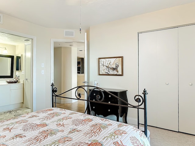 3333 S Atlantic Ave Unit 505, Daytona Beach, FL 32118 - bedroom featuring a closet, ensuite bathroom, and baseboards