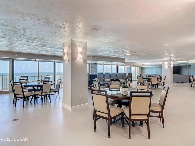 3333 S Atlantic Ave Unit 505, Daytona Beach, FL 32118 - dining space featuring plenty of natural light, ceiling fan, and baseboards