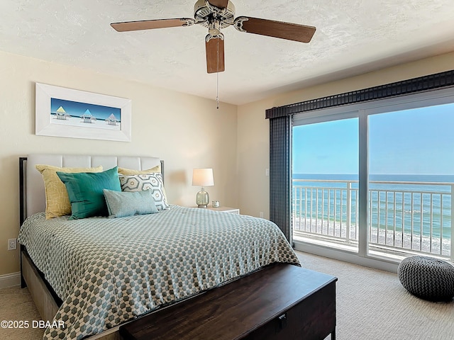 3333 S Atlantic Ave Unit 505, Daytona Beach, FL 32118 - carpeted bedroom with access to exterior, a ceiling fan, a water view, and baseboards