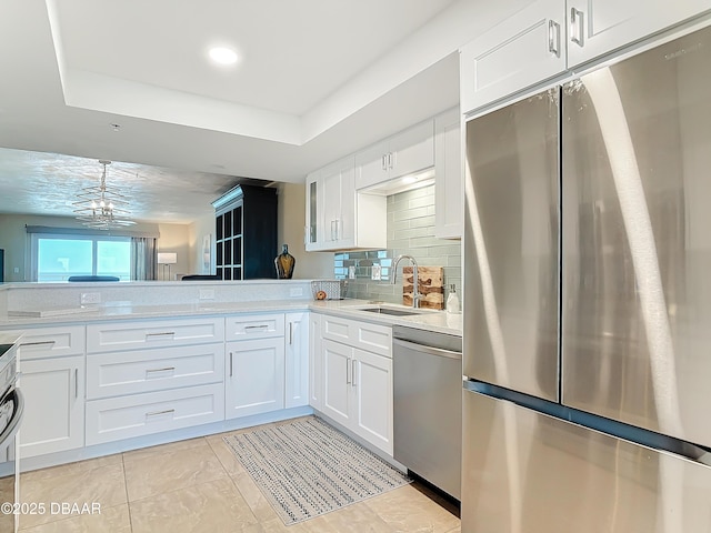 3333 S Atlantic Ave Unit 505, Daytona Beach, FL 32118 - kitchen with appliances with stainless steel finishes, a sink, white cabinets, and light countertops