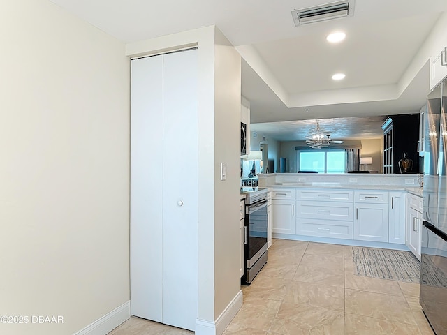 3333 S Atlantic Ave Unit 505, Daytona Beach, FL 32118 - kitchen with appliances with stainless steel finishes, white cabinetry, and light countertops